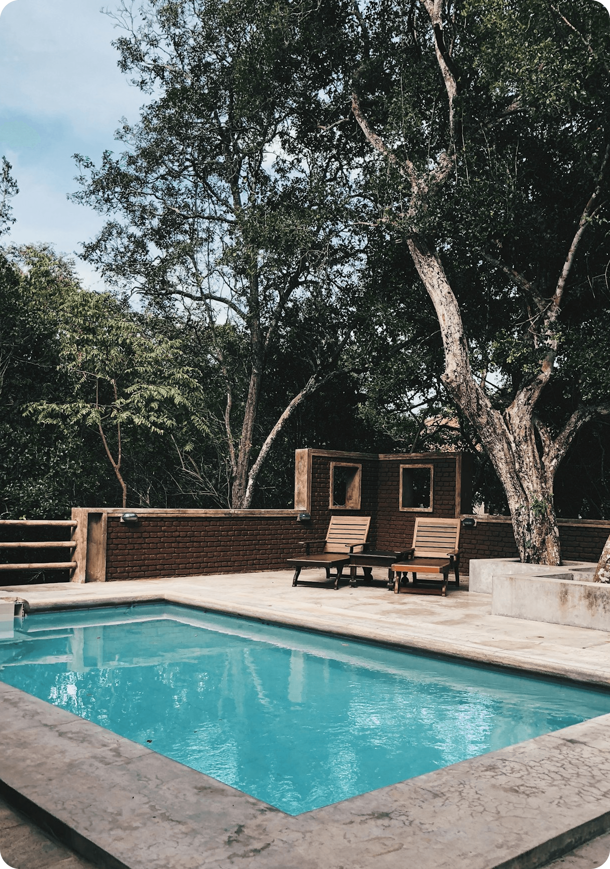 Luxury pool with wooden deck chairs